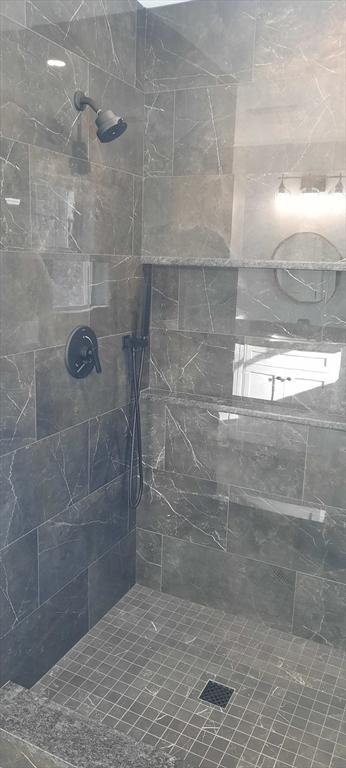 bathroom with tiled shower