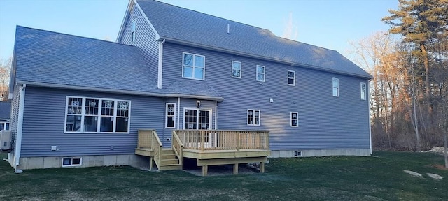 back of house with a wooden deck and a yard