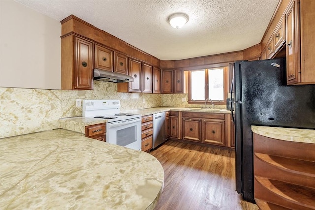 20 Cady St, Ludlow, MA 01056 - kitchen with white range with electric stovetop, under cabinet range hood, freestanding refrigerator, stainless steel dishwasher, and a textured ceiling