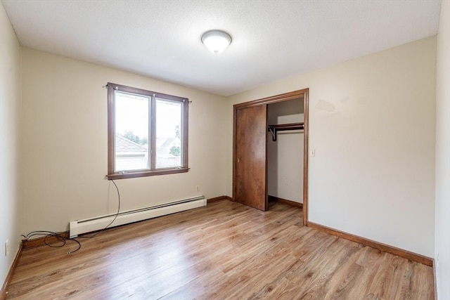20 Cady St, Ludlow, MA 01056 - unfurnished bedroom featuring a baseboard radiator, light wood finished floors, and a closet