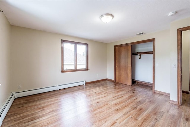 20 Cady St, Ludlow, MA 01056 - unfurnished bedroom featuring light wood-type flooring, a baseboard radiator, and a closet
