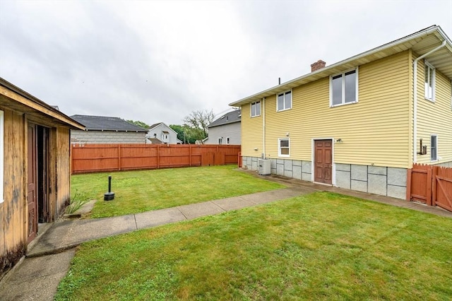 20 Cady St, Ludlow, MA 01056 - back of property featuring a chimney and a fenced backyard