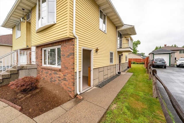 20 Cady St, Ludlow, MA 01056 - view of side of home with brick siding and driveway