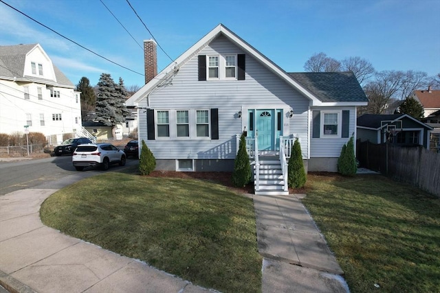 bungalow-style home with a front lawn