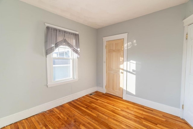 spare room with light hardwood / wood-style flooring