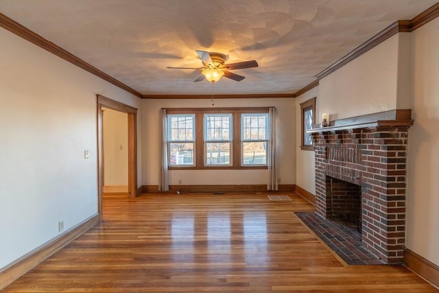 unfurnished living room with a fireplace, hardwood / wood-style flooring, ornamental molding, ceiling fan, and a textured ceiling