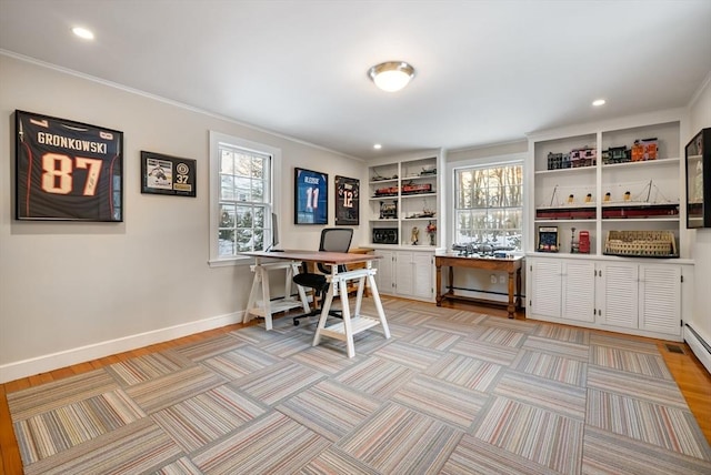 home office featuring crown molding, a baseboard radiator, and built in features