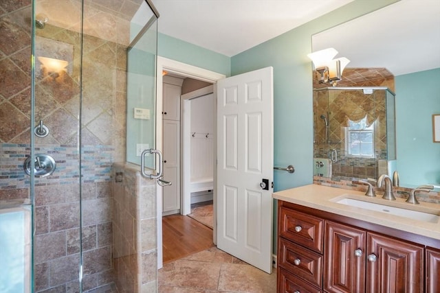 bathroom with tile patterned floors, vanity, and a shower with shower door