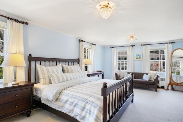 bedroom featuring multiple windows and light carpet