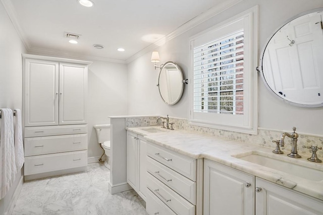 bathroom with vanity, ornamental molding, and toilet