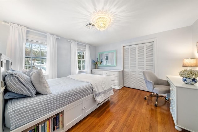 bedroom with a closet and light hardwood / wood-style flooring