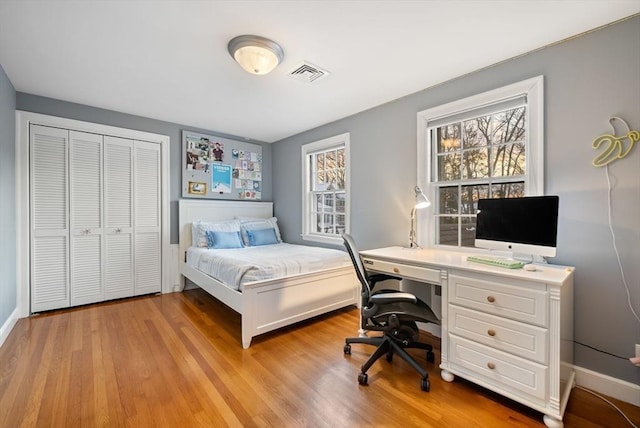 bedroom featuring a closet and light wood-type flooring