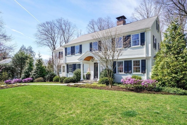 colonial-style house with a front yard