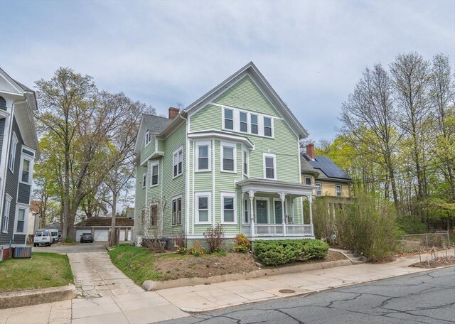 172 Doyle Ave Unit 1, Providence, RI 02906 - view of front of home with a garage, a chimney, a porch, and central AC