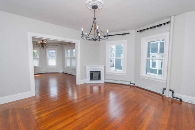 172 Doyle Ave Unit 1, Providence, RI 02906 - unfurnished living room featuring an inviting chandelier, a baseboard radiator, a glass covered fireplace, and wood finished floors