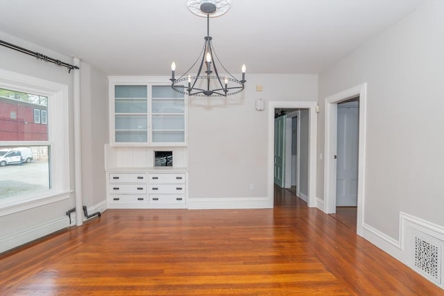 172 Doyle Ave Unit 1, Providence, RI 02906 - unfurnished dining area featuring baseboards, an inviting chandelier, and wood finished floors