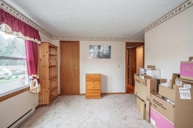 453 Homestead Ave, Holyoke, MA 01040 - bedroom featuring baseboard heating, a textured ceiling, light carpet, multiple windows, and baseboards