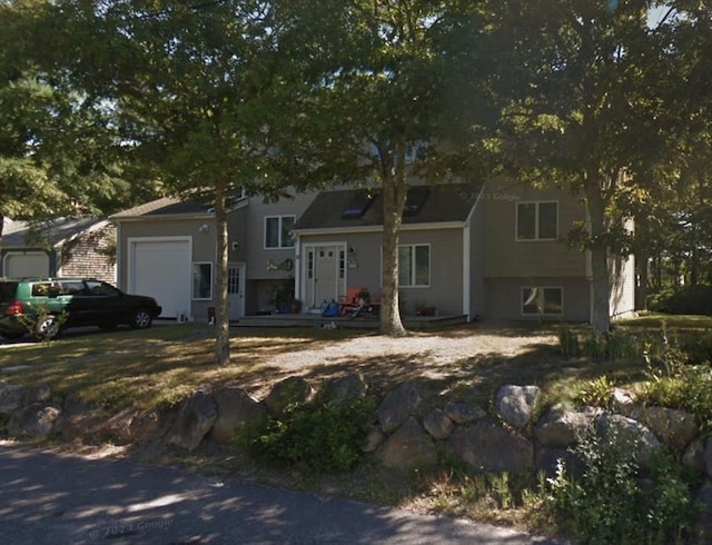 view of front of home featuring a garage and a wooden deck