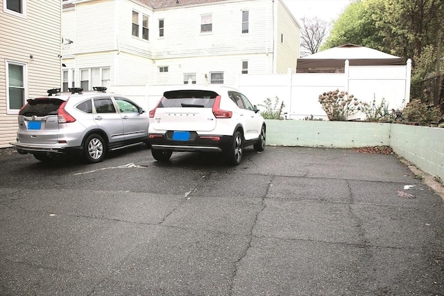 view of parking with fence