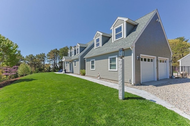 view of side of home featuring a yard and a shingled roof