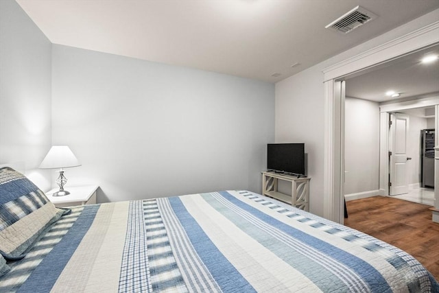 bedroom featuring wood finished floors and baseboards