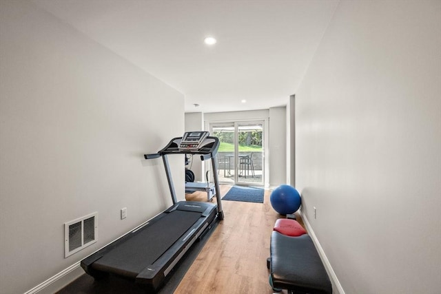 exercise room featuring wood finished floors, baseboards, and recessed lighting