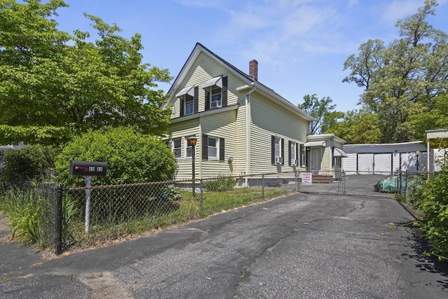 40 By St, Lowell, MA 01850 - view of side of home with a chimney, a gate, and asphalt driveway