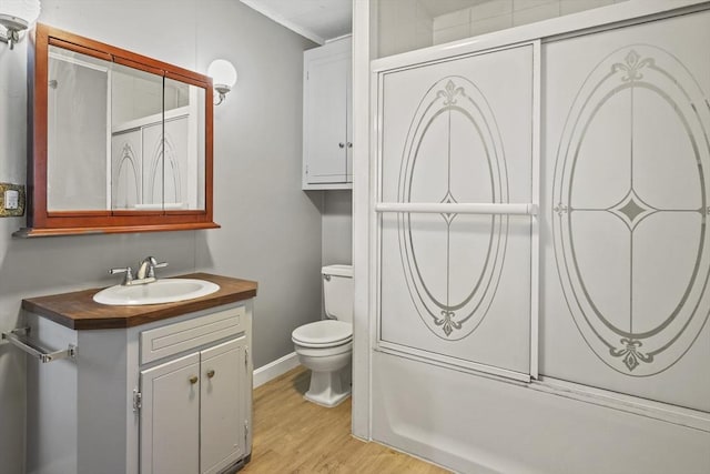 40 By St, Lowell, MA 01850 - bathroom with vanity, toilet, wood finished floors, ornamental molding, and baseboards