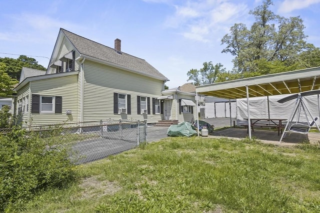 40 By St, Lowell, MA 01850 - back of property with a chimney and roof with shingles