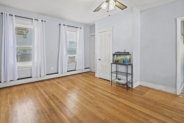 40 By St, Lowell, MA 01850 - unfurnished bedroom with light wood-type flooring, a baseboard heating unit, a ceiling fan, and baseboards