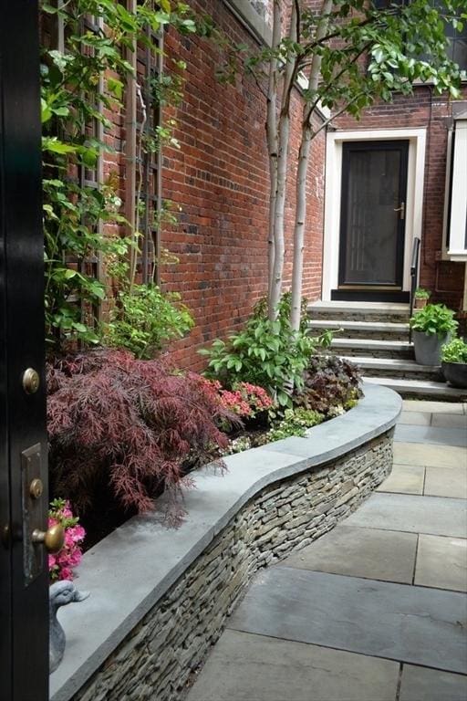 property entrance featuring brick siding