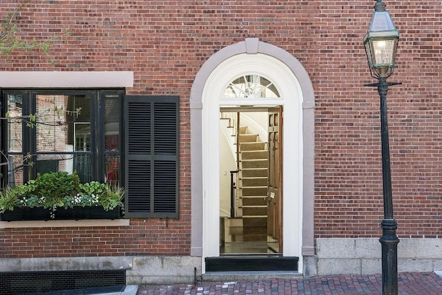 property entrance featuring brick siding