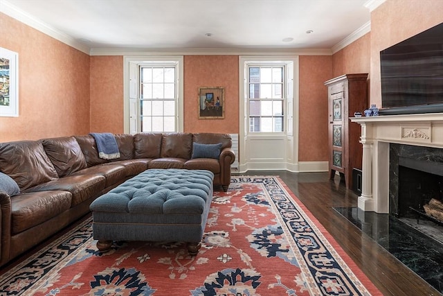 living area featuring ornamental molding, a fireplace, plenty of natural light, and dark wood-type flooring