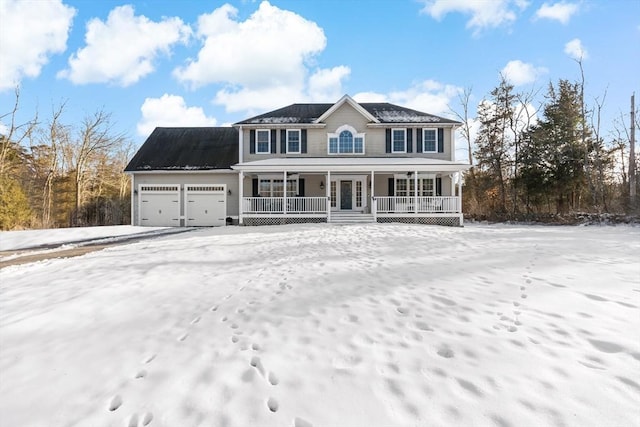 colonial home with covered porch and an attached garage