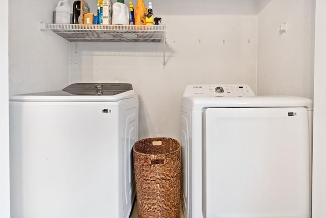 clothes washing area featuring laundry area and washer and clothes dryer