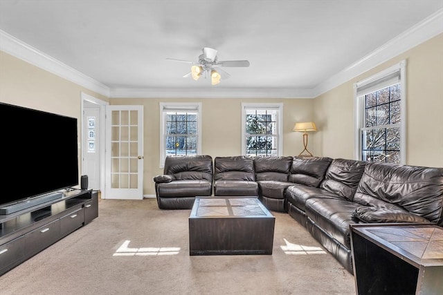 living area with crown molding, a ceiling fan, and light carpet