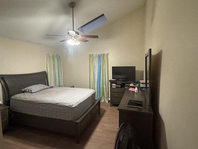 bedroom with lofted ceiling, wood finished floors, and a ceiling fan