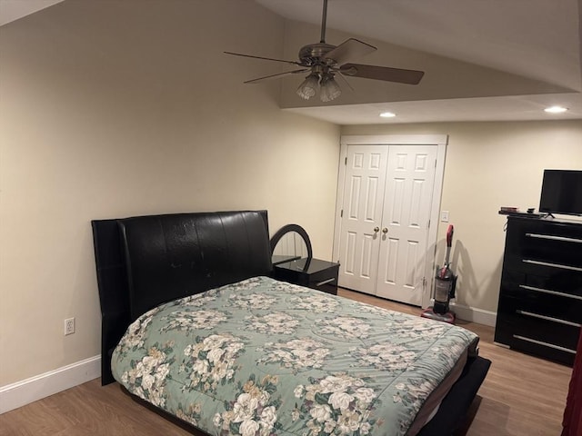 bedroom with recessed lighting, baseboards, lofted ceiling, and wood finished floors