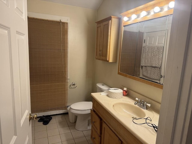 bathroom with vanity, tile patterned floors, and toilet