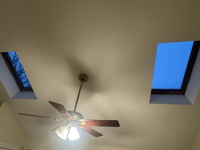 interior details with a skylight and a ceiling fan