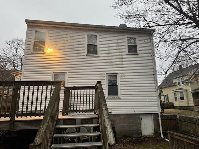 rear view of property with a deck and fence