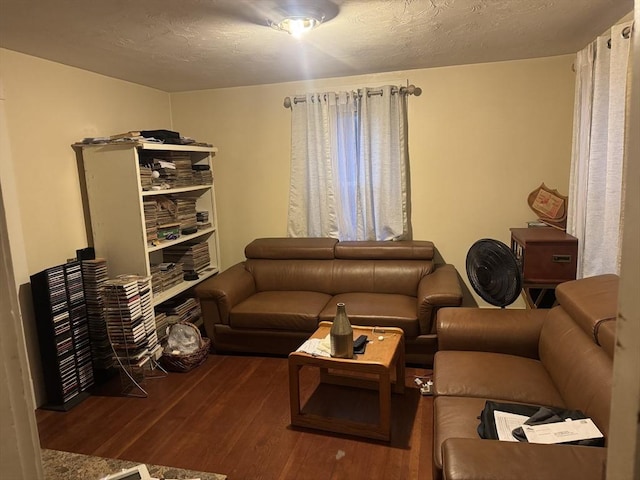 living area with a textured ceiling and wood finished floors