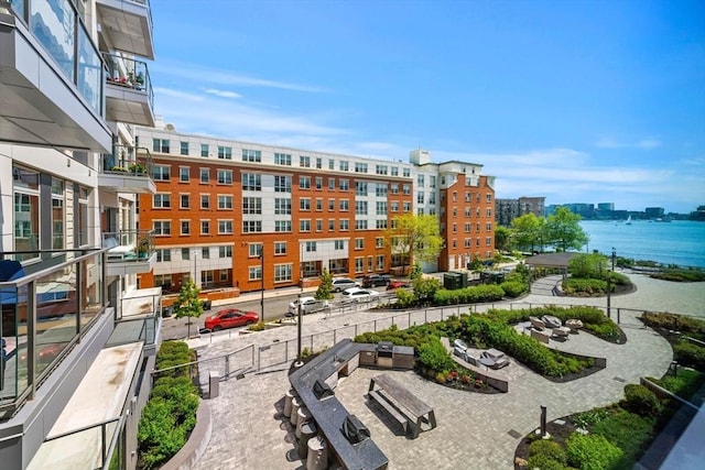 surrounding community featuring a view of city and a water view