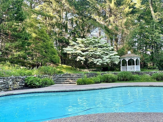 view of swimming pool featuring a gazebo