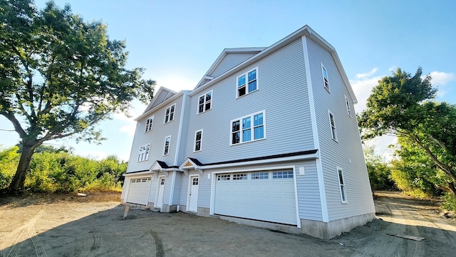 exterior space featuring a garage and central AC