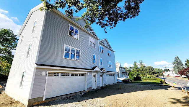 back of house featuring a garage