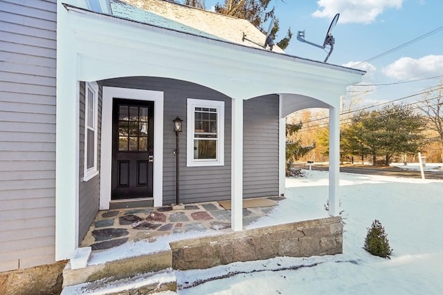 view of snow covered property entrance