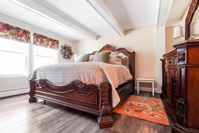 bedroom featuring beamed ceiling, a baseboard heating unit, and wood finished floors