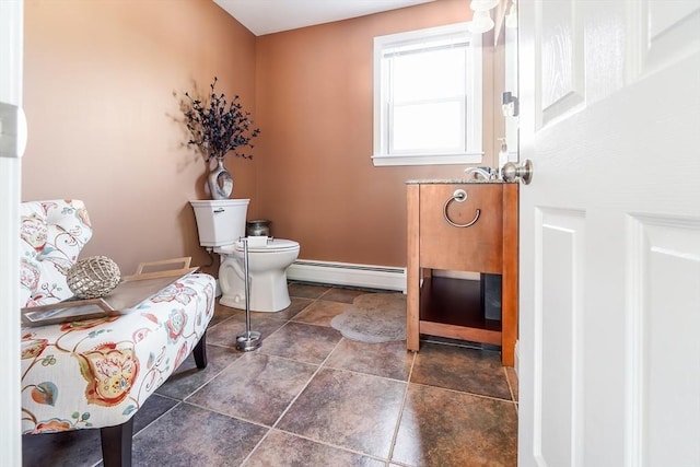 bathroom featuring toilet, baseboards, and a baseboard radiator