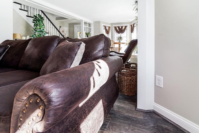 living area with stairway, wood finished floors, and baseboards